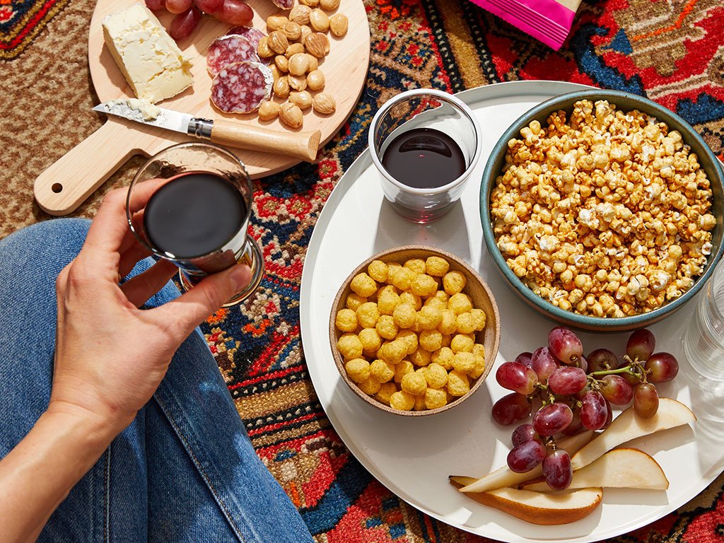 Cozy virtual date night setup with snacks and wine for long-distance couples.